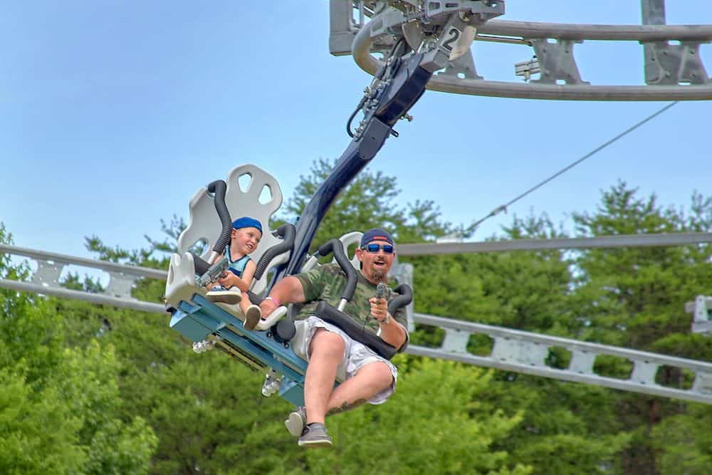 family riding the Ski Lift Shootout Coaster at Rowdy Bear