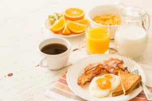 coffee, eggs, bacon, toast, orange juice, milk