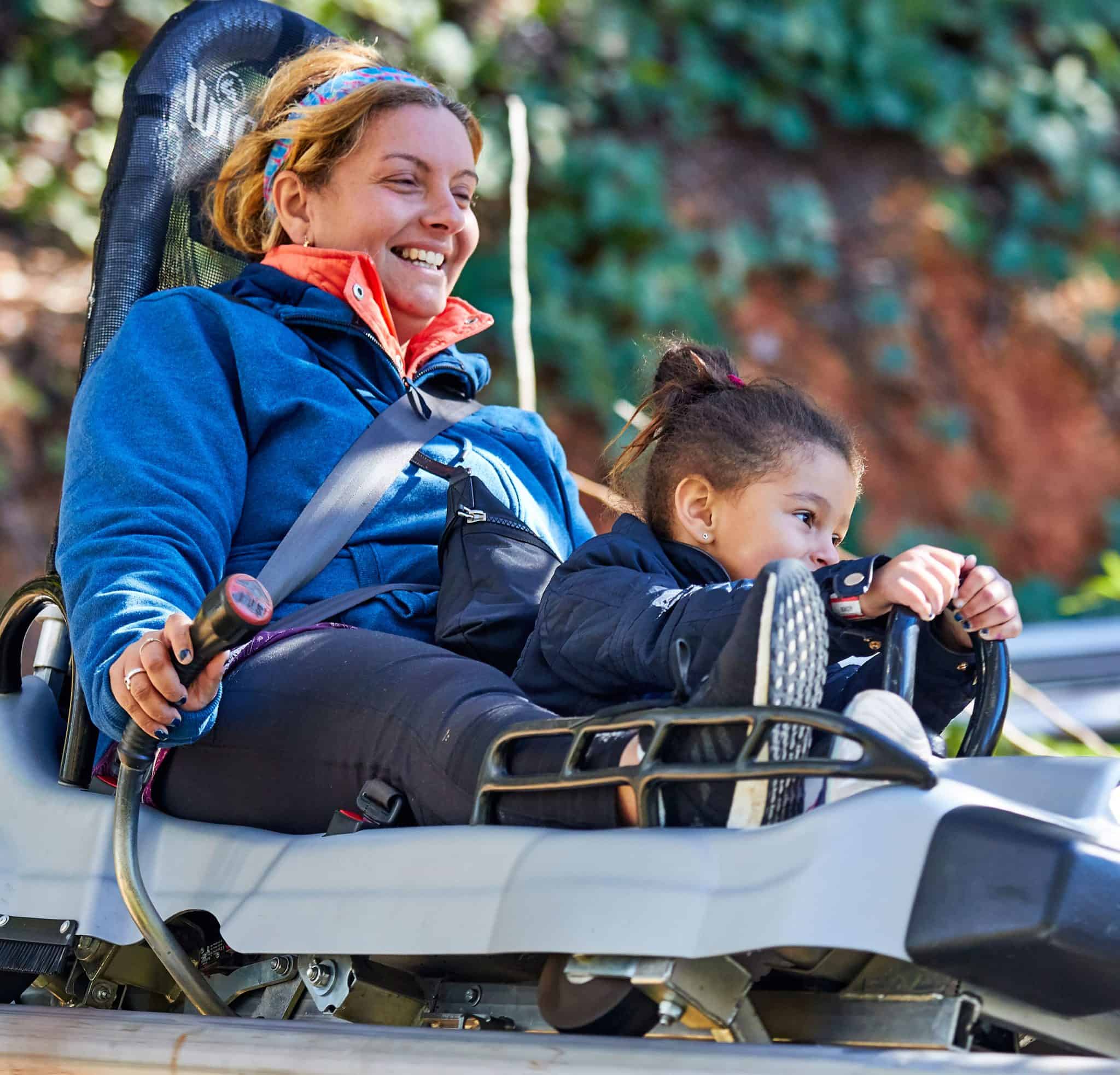 Mom and daughter riding Alpine Coaster