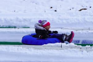 girl snow tubing in pigeon forge at rowdy bear's smoky mountain snowpark