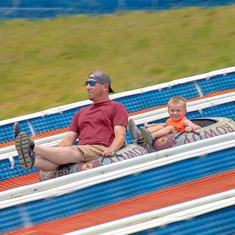 Family riding down Tubing Hill
