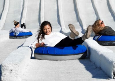 female friends on the outdoor snow tubing hill