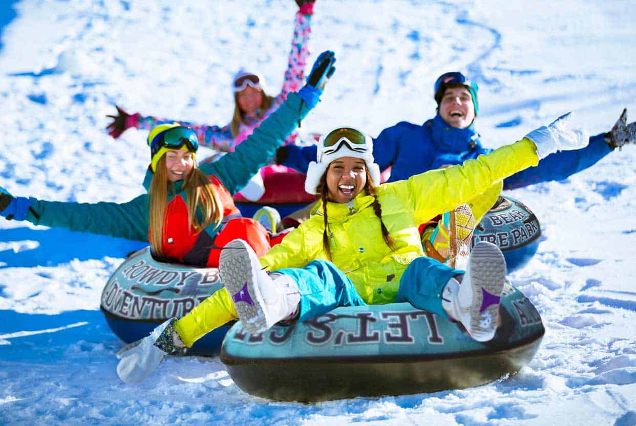 people on snow tubes in the snow